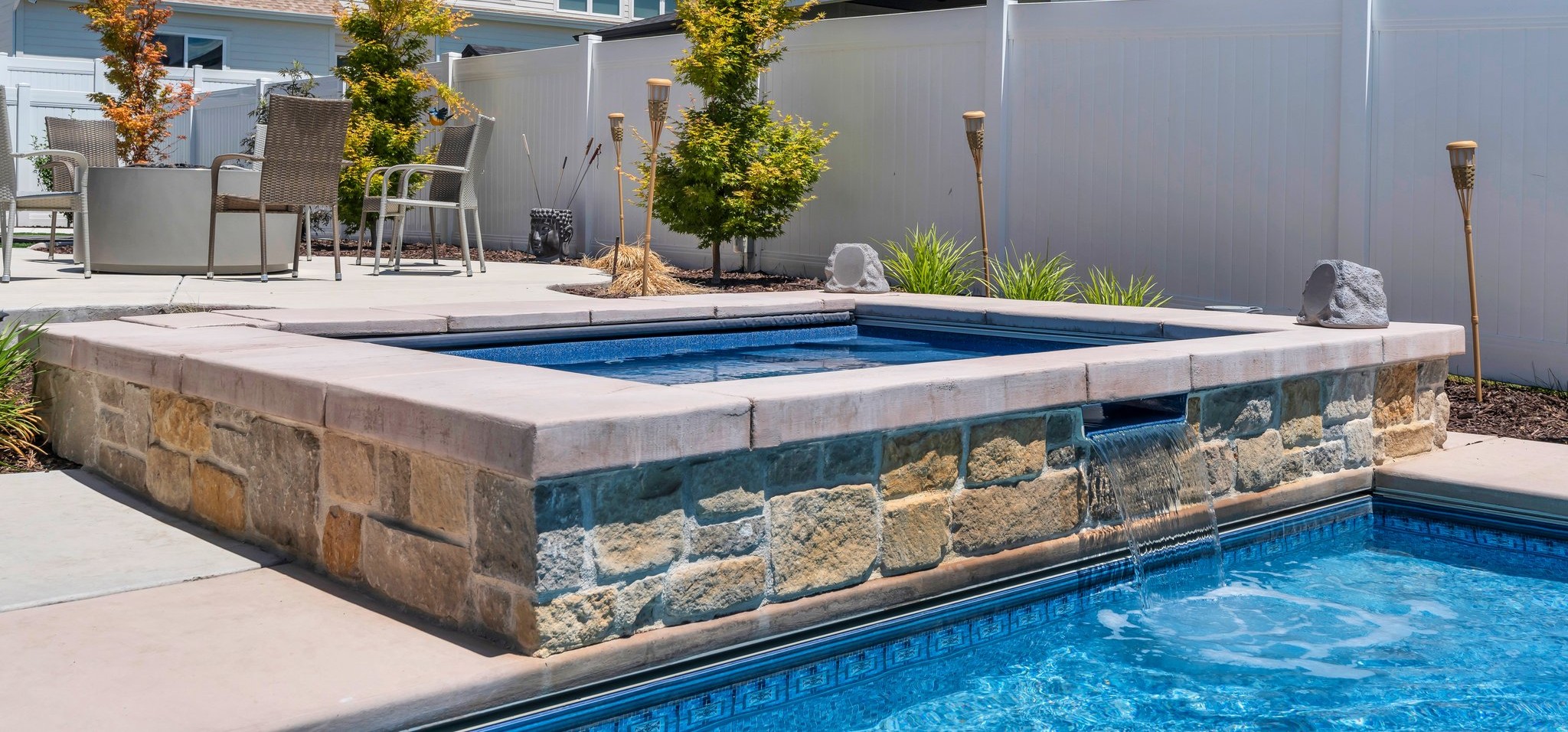 Simple gunite concrete pool example with modest raised water feature